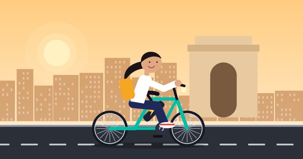 Electric cycle with a city skyline and a monument-style gate in the background